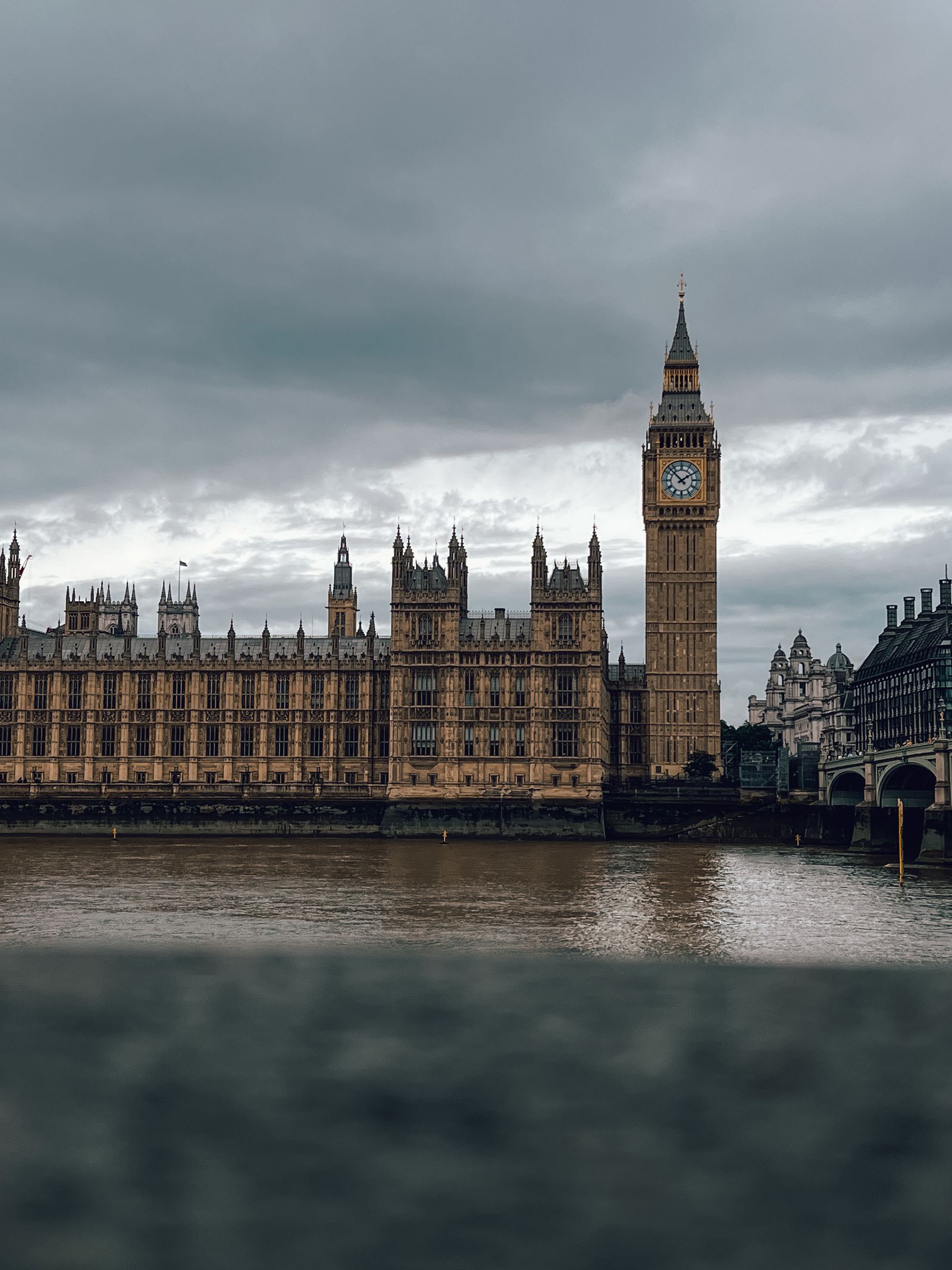 Big Ben and the Houses of Parliament across the River Thames under cloudy skies