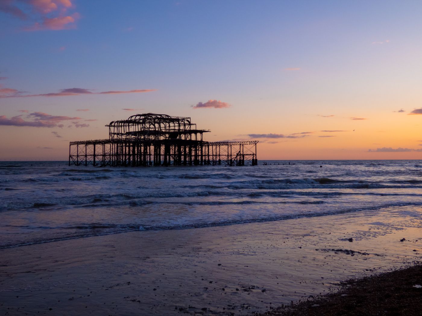 Brighton West Pier silhouetted against a vivid sunset sky