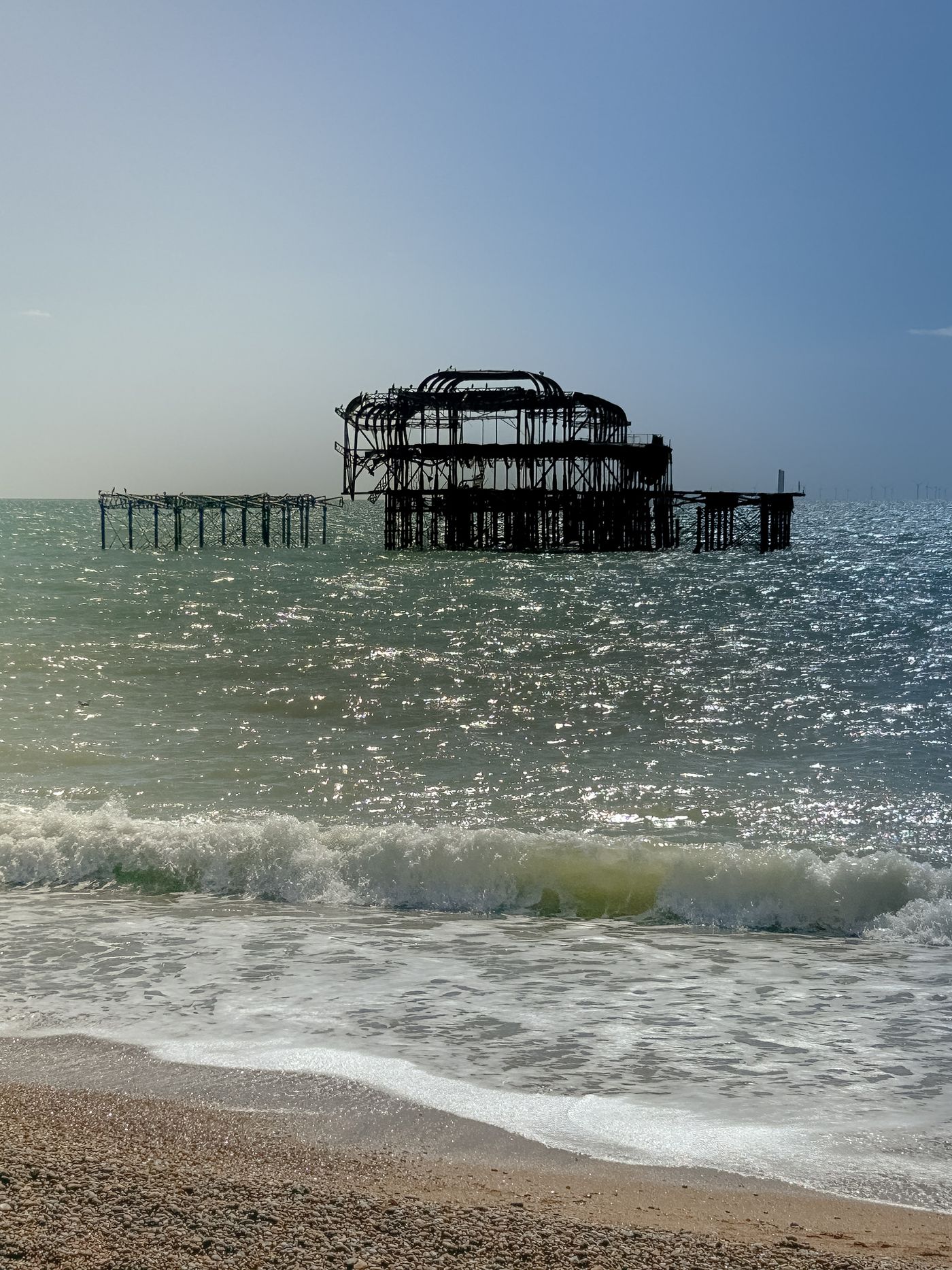 The remains of Brighton West Pier standing in the sea at dusk