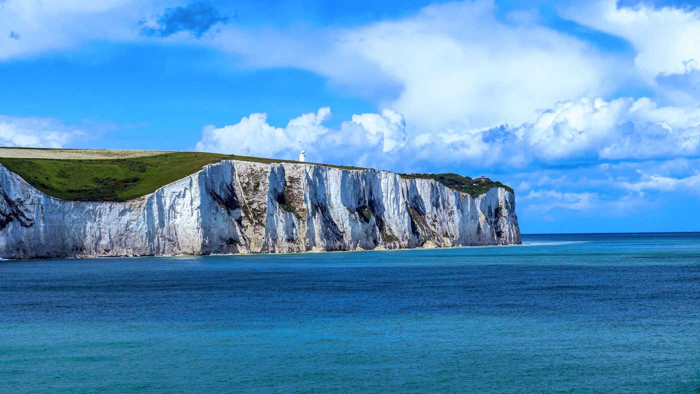 The white chalk cliffs of Dover meeting a bright blue sea