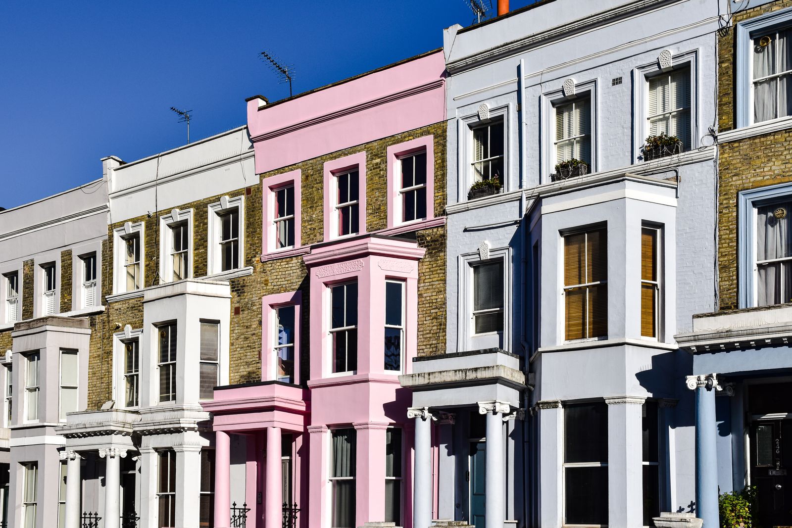 Rows of brightly painted Victorian houses in Notting Hill, London