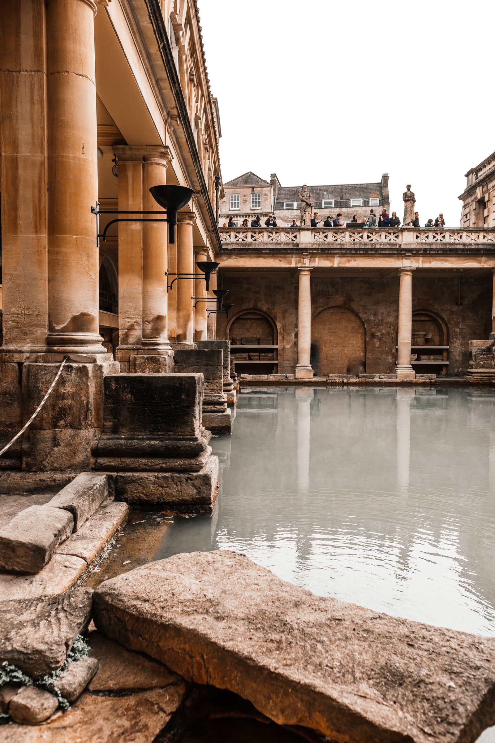Columns and green water at the Roman Baths in Bath