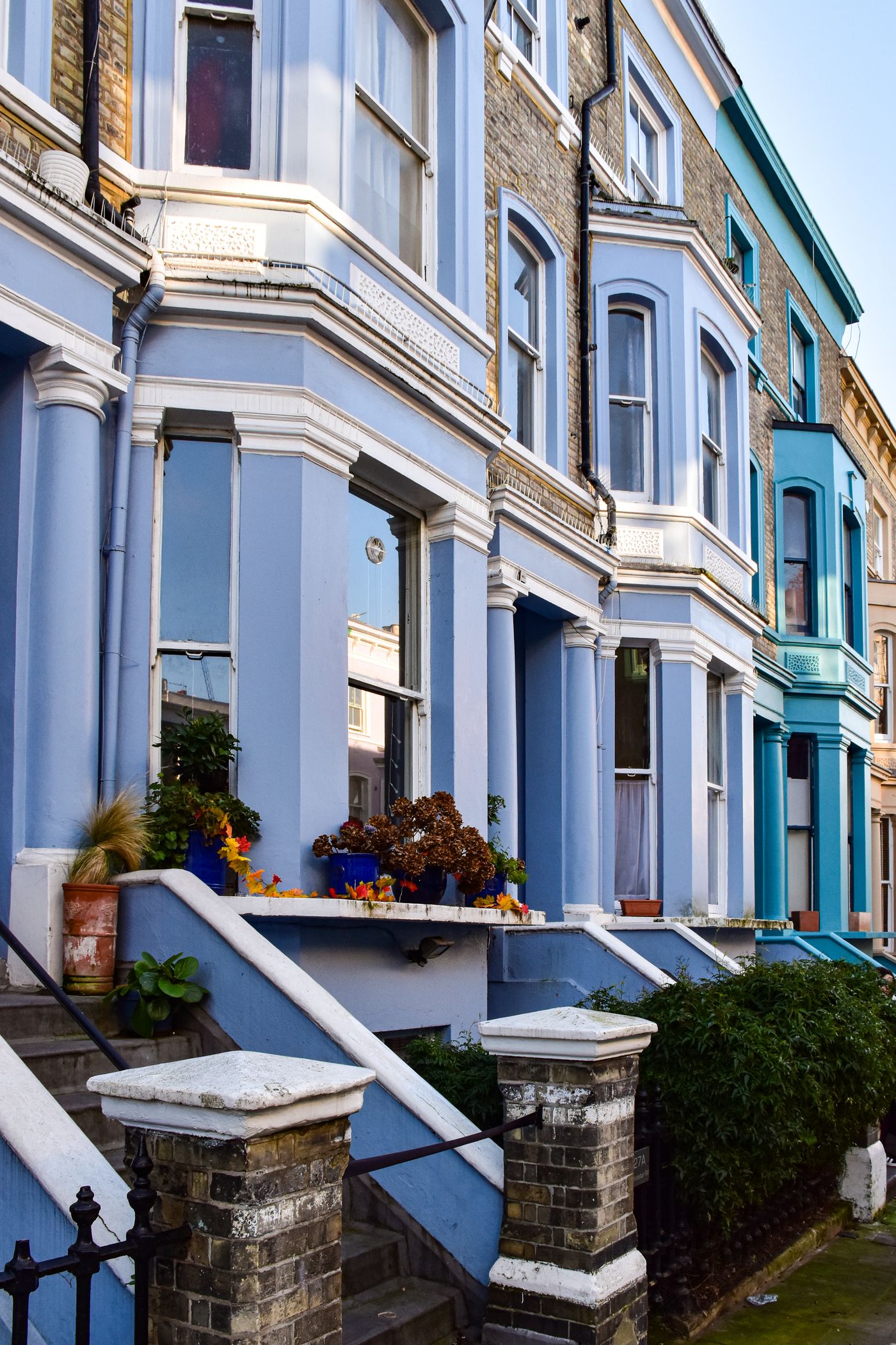 A row of traditional English terraced houses with bay windows