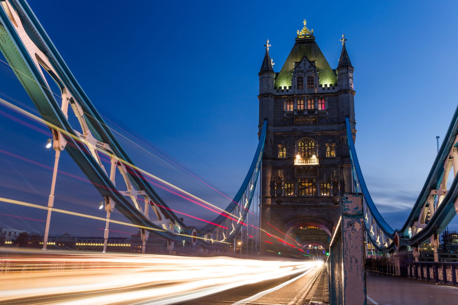 Tower Bridge lit up at night with light trails from passing traffic