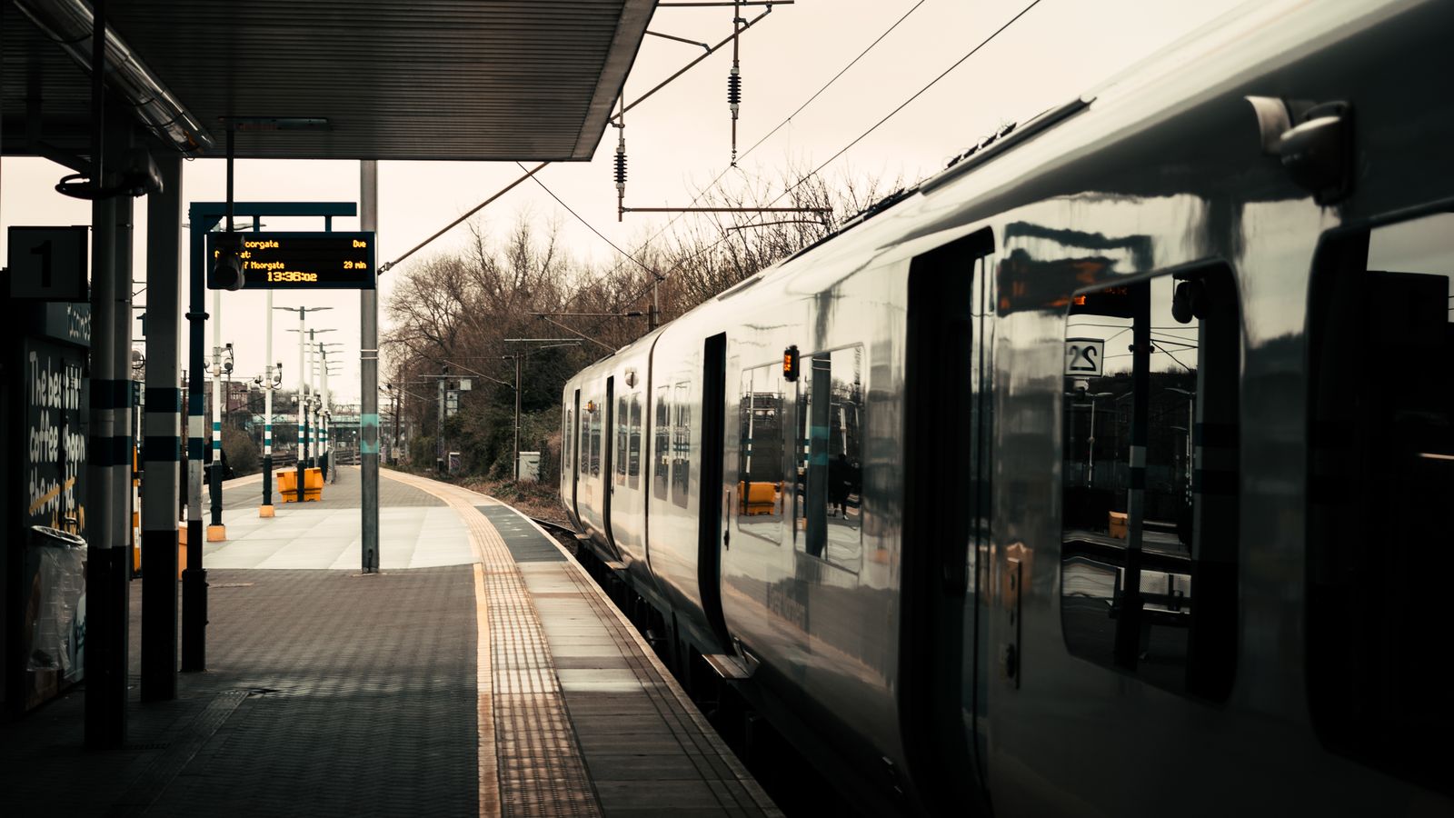 A sleek passenger train at a London railway station platform