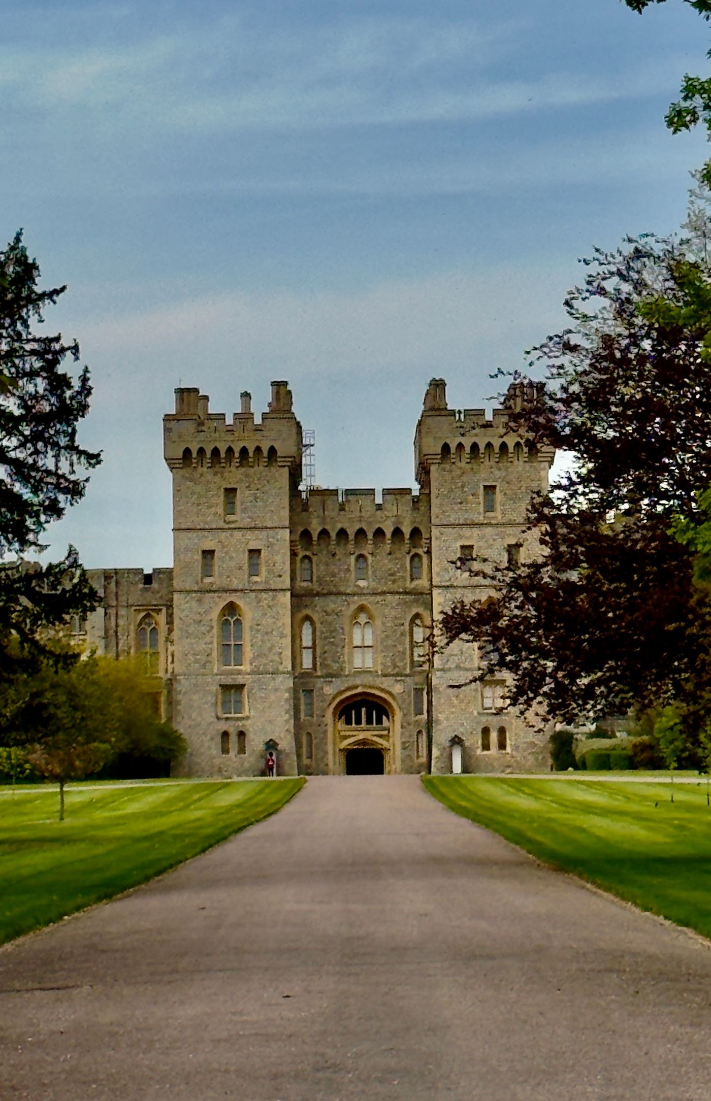 A tree-lined path leading to the entrance of Windsor Castle in spring