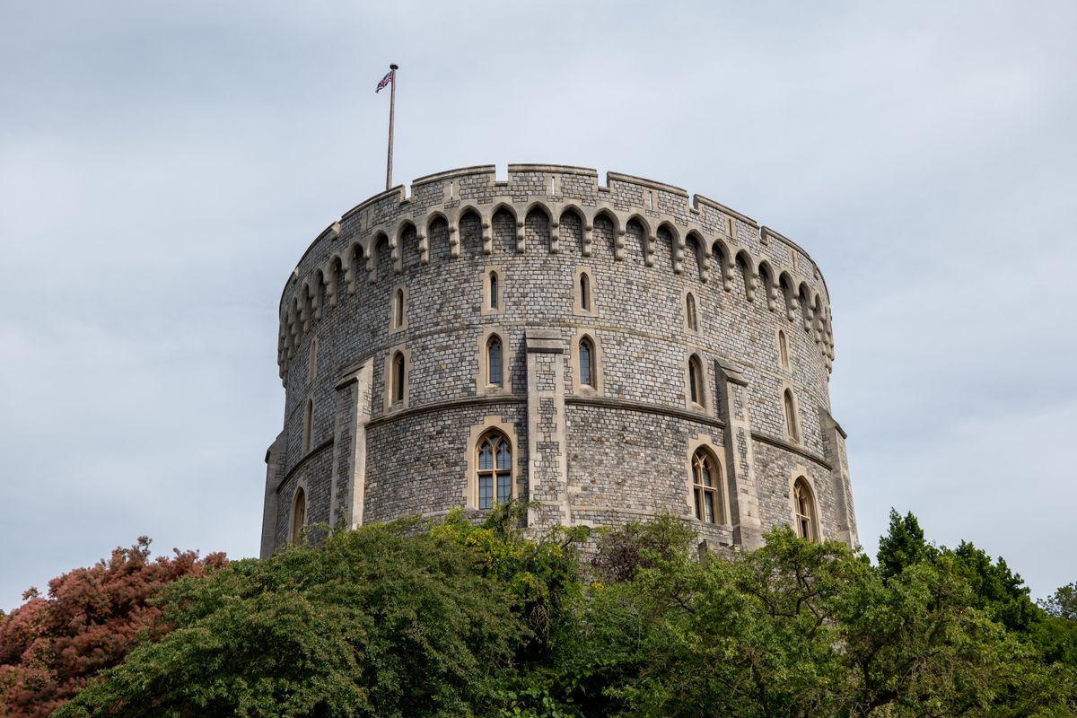 The round tower of Windsor Castle rising above stone walls